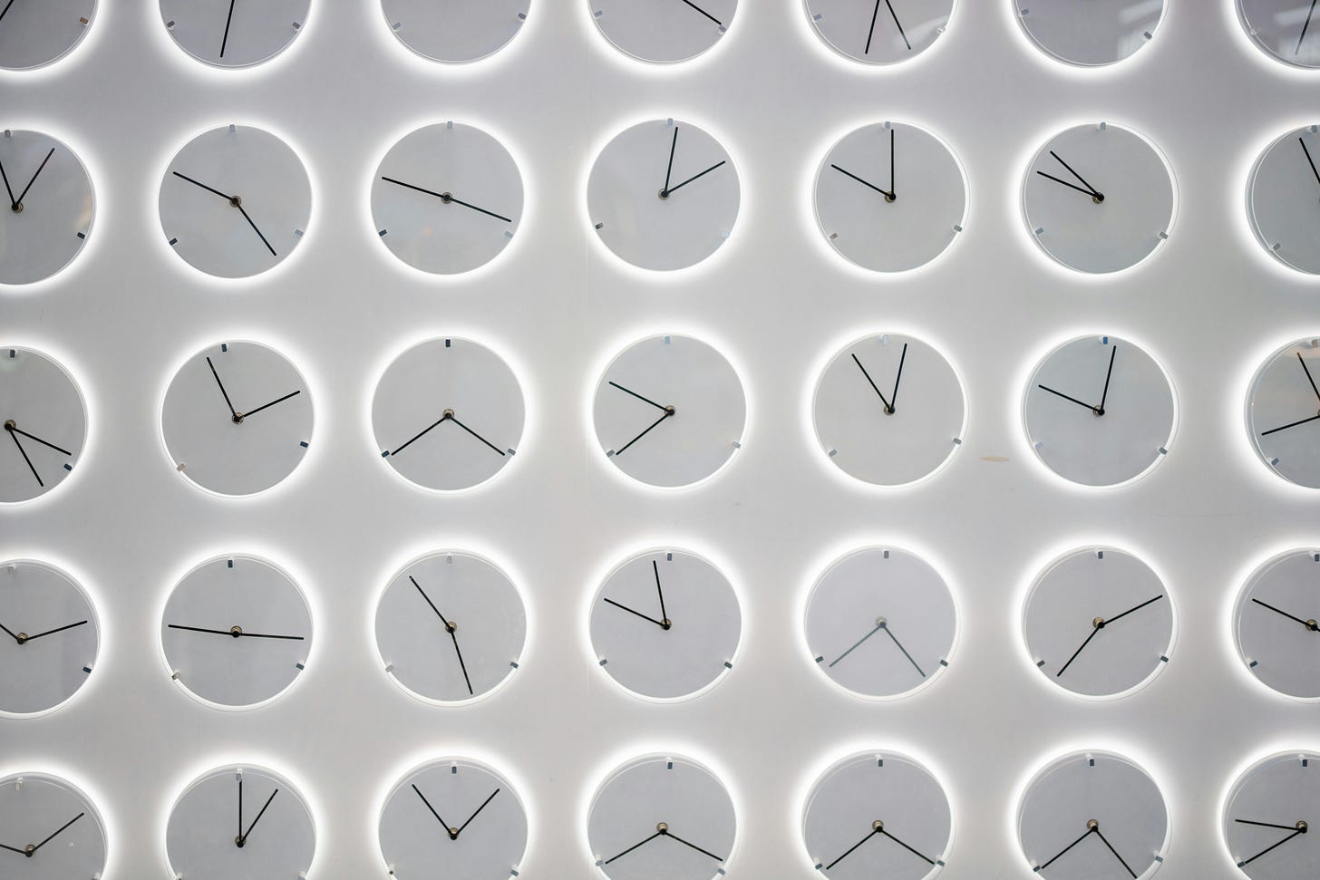 Analog clock faces with different hand sequences all on a grey background with white borders Analog clock faces with different hand sequences all on a grey background with white borders