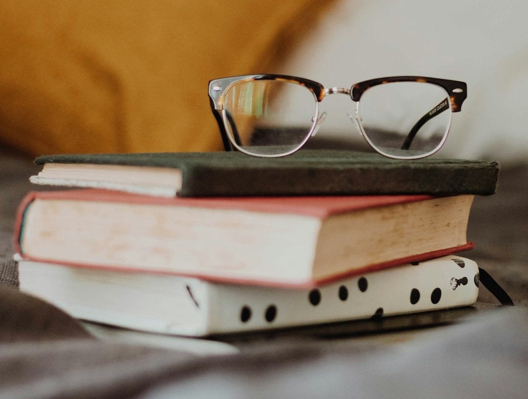 club master eyeglasses on pile of three books club master eyeglasses on pile of three books