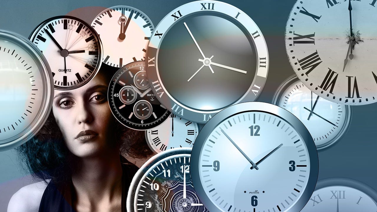 A woman-s face surrounded by watch faces A woman-s face surrounded by watch faces
