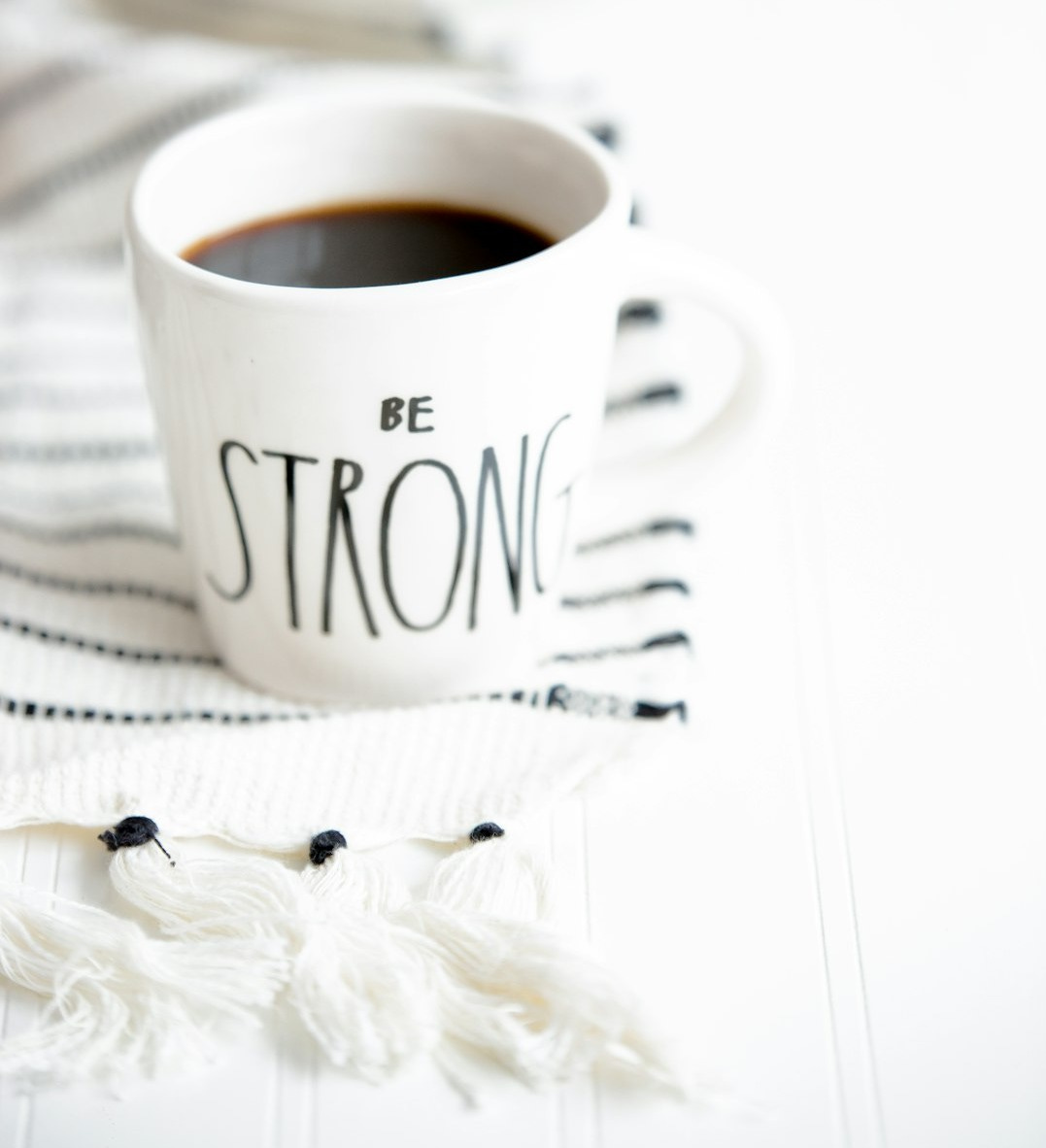 white ceramic mug filled with black coffee