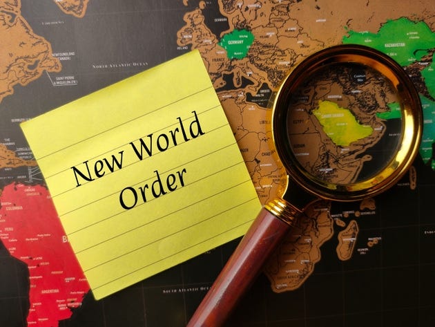 Magnifying glass and sticky note with text New World Order on a world map Magnifying glass and sticky note with text New World Order on a world map