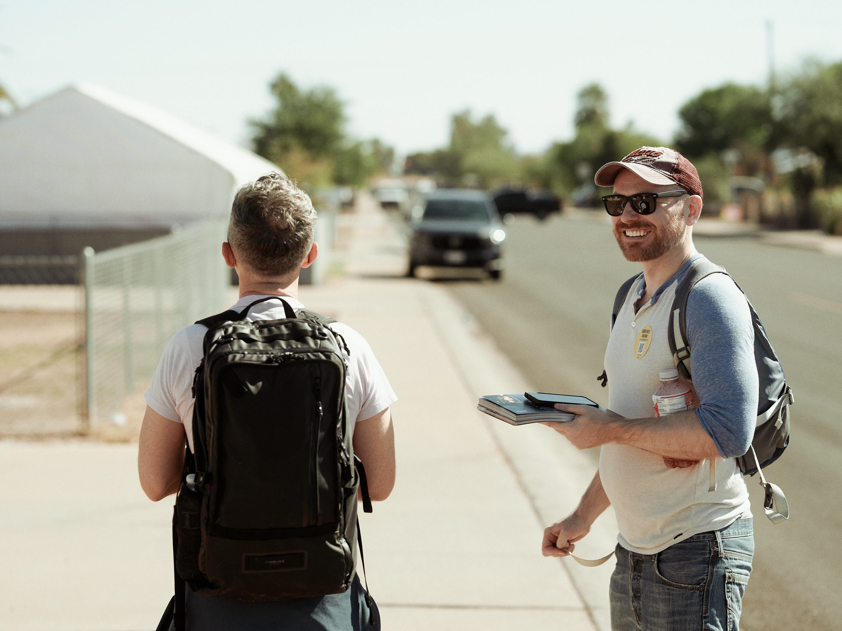 Canvassing volunteers smiling after a meaningful connection with a voter during their shift in Phoenix Arizona photographed by LA documentary photographer Afonso Salcedo Canvassing volunteers smiling after a meaningful connection with a voter during their shift in Phoenix Arizona photographed by LA documentary photographer Afonso Salcedo