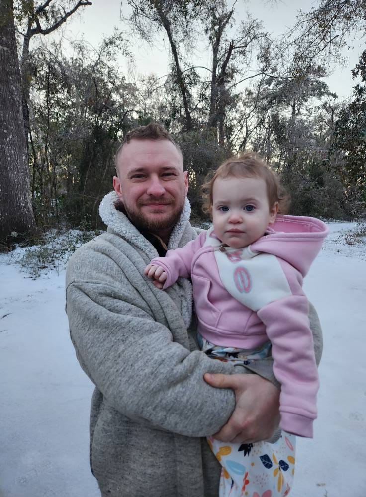 May be an image of 1 person, baby and snowball