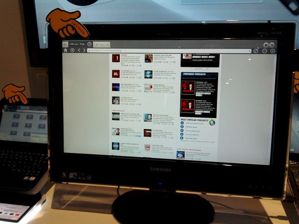 A PC screen showing a finger that says "touch here". On the screen there is a non-standard browser (not Internet Explorer or Firefox) connected to twitter. A PC screen showing a finger that says "touch here". On the screen there is a non-standard browser (not Internet Explorer or Firefox) connected to twitter.