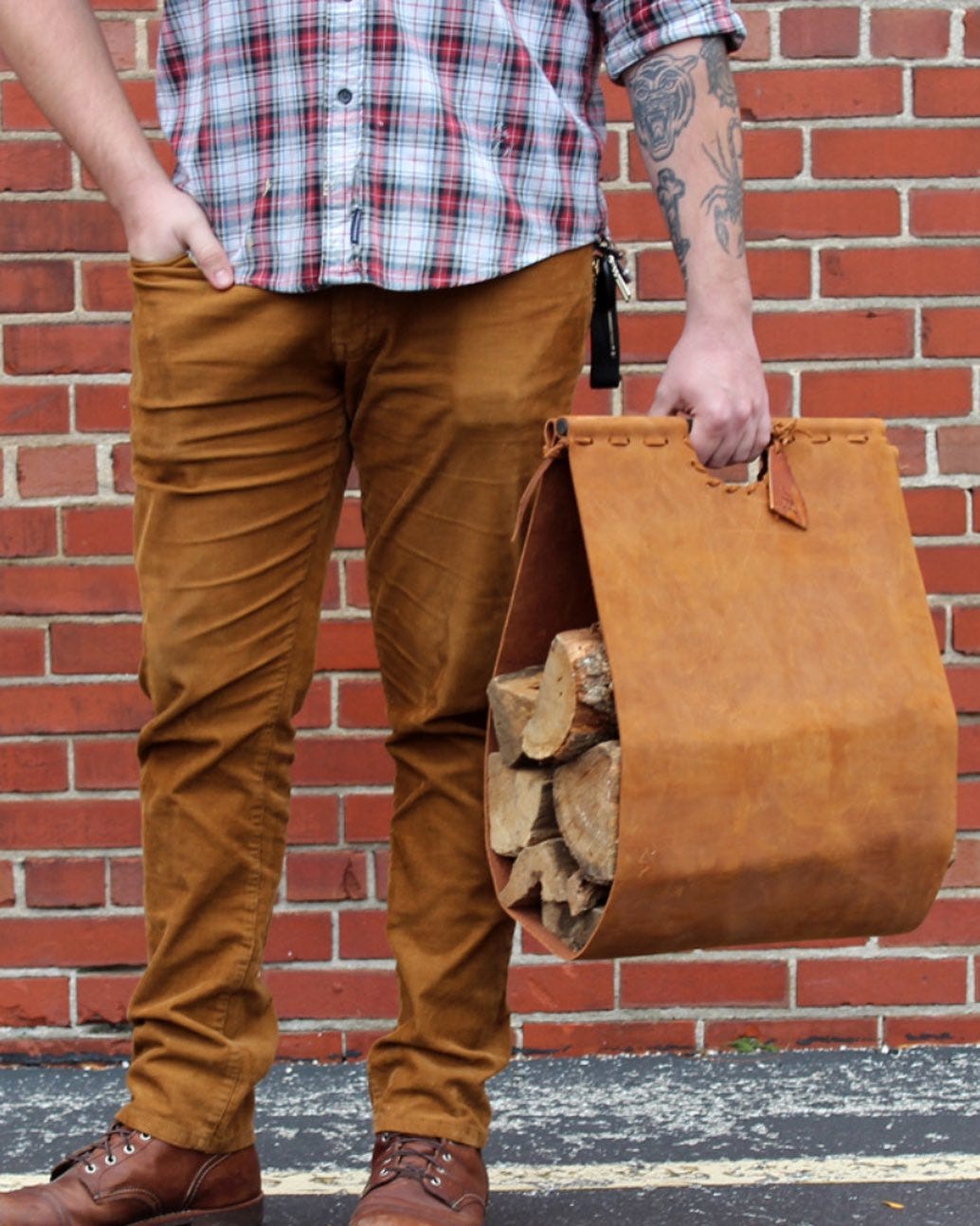 May be an image of 1 person, saddle-stitched leather, suitcase, tool bag and leather