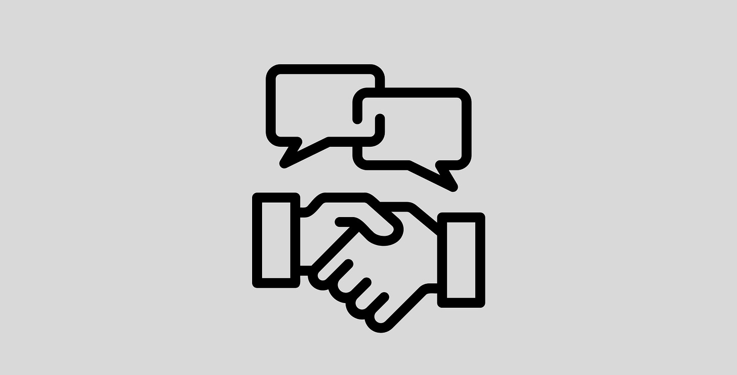 A graphic of two hands shaking in a greeting with two blank interlocking conversation bubbles over each hand. A graphic of two hands shaking in a greeting with two blank interlocking conversation bubbles over each hand.