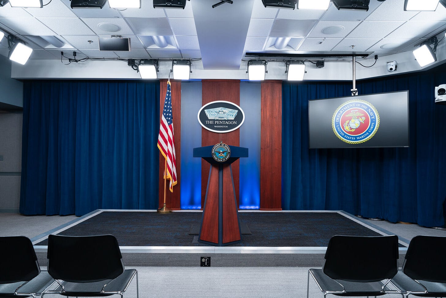 Direct view of the podium and stage of the Pentagon Briefing Room.