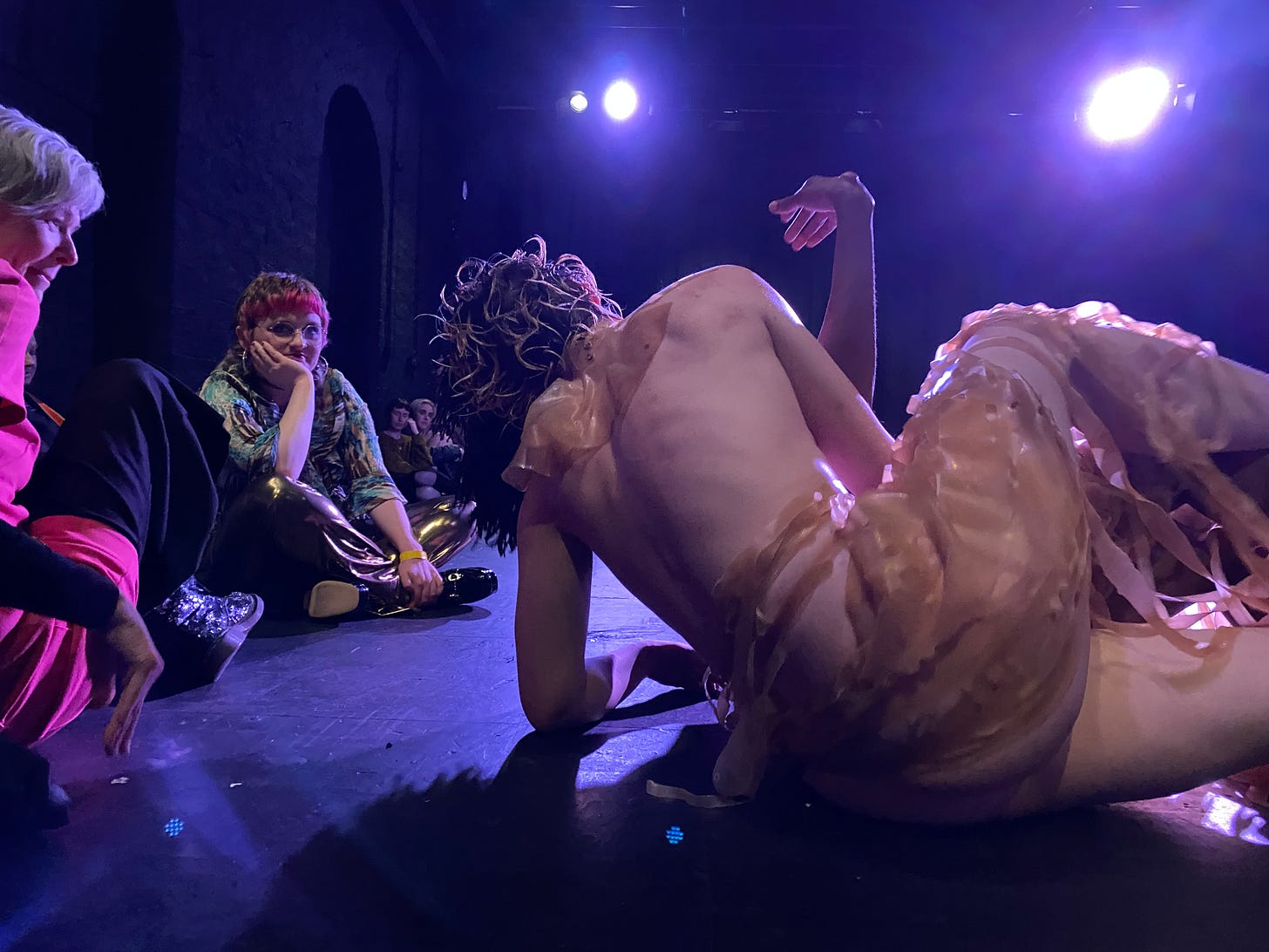 women covered in seaweed rolling on the floor