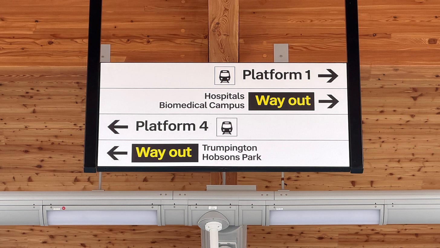 Photo of a wayfinding sign at the top of the platform 2/3 stairs.