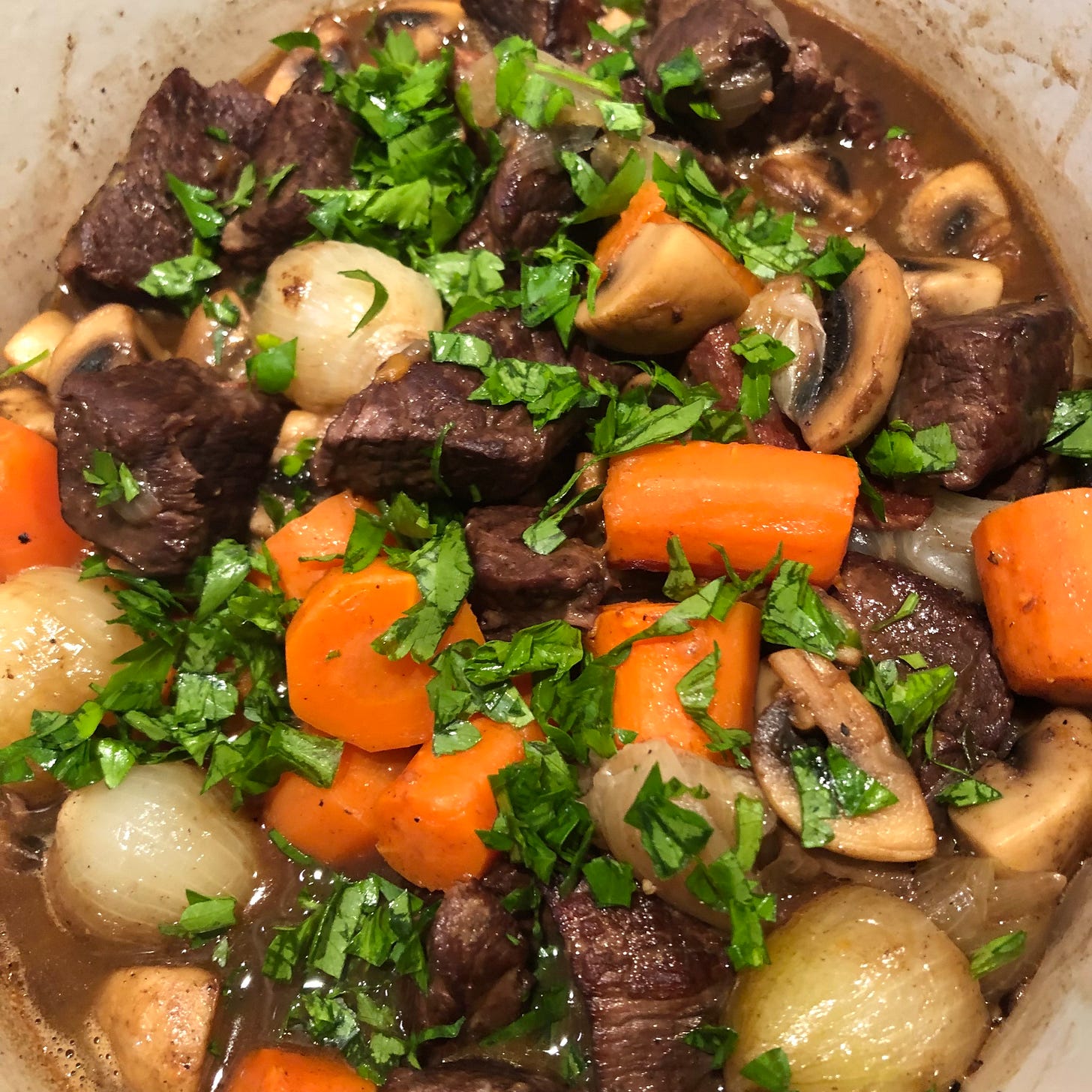 Boeuf Bourguignon with carrots in a stew pot. Boeuf Bourguignon with carrots in a stew pot.
