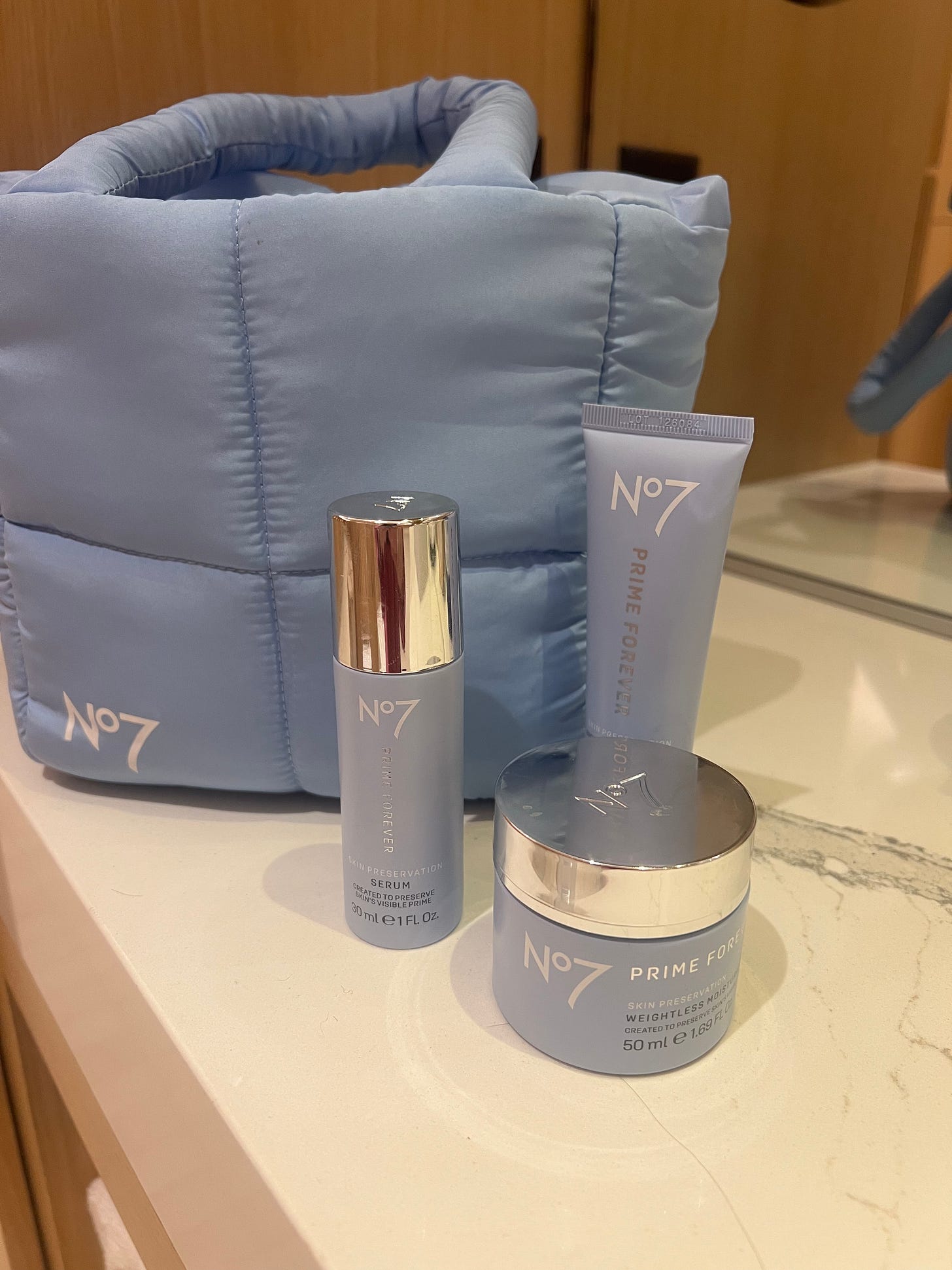 A picture of the No7 Prime Forever Serum, SPF50 Primer and Weightless Moisturiser next to a No7 branded blue padded bag A picture of the No7 Prime Forever Serum, SPF50 Primer and Weightless Moisturiser next to a No7 branded blue padded bag