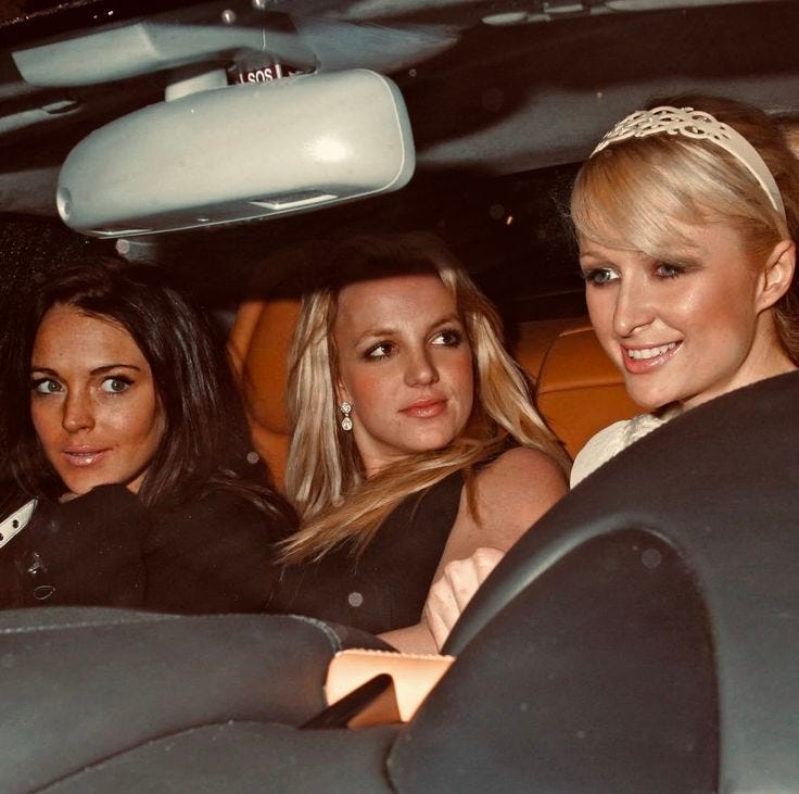 This may contain: three women sitting in the back seat of a car, one wearing a tiara This may contain: three women sitting in the back seat of a car, one wearing a tiara