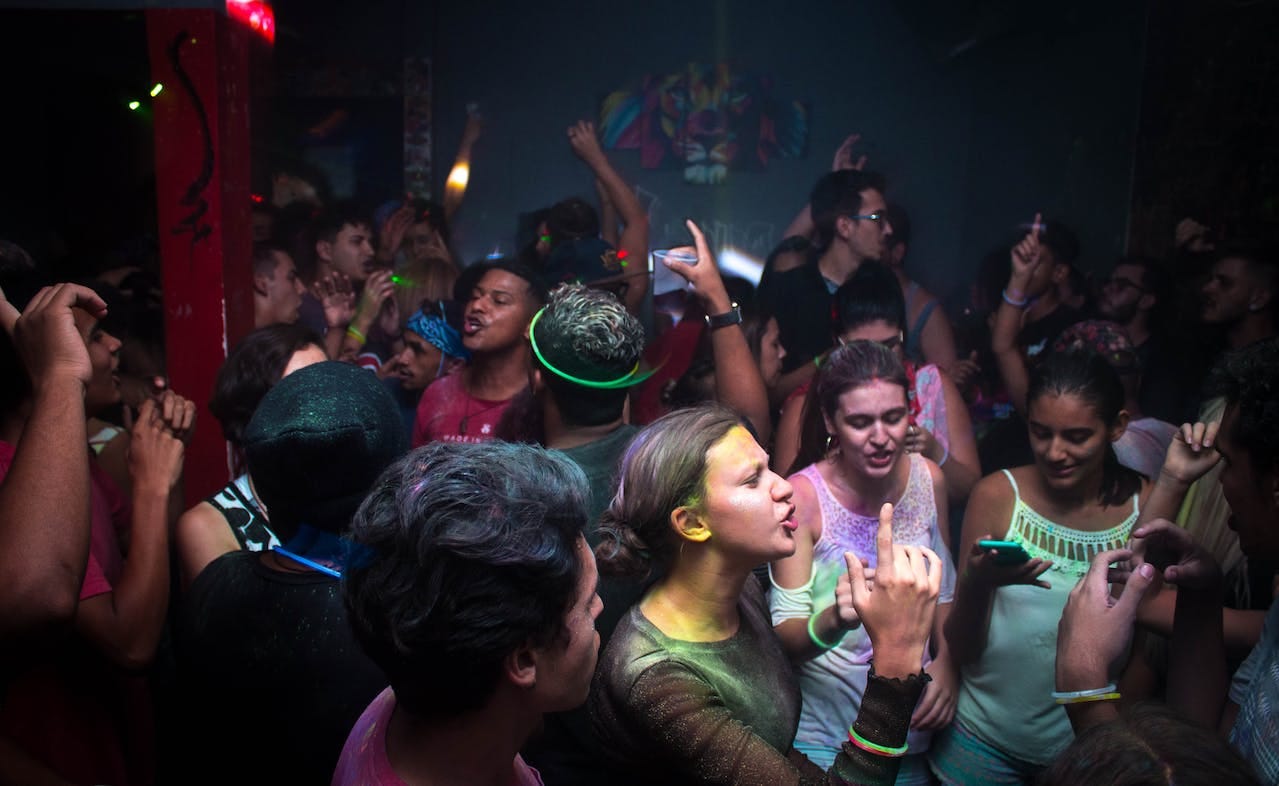 Crowd partying in a dark room