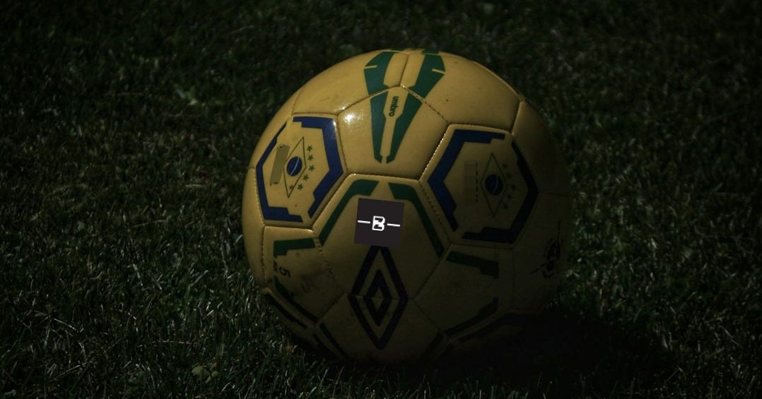 yellow and black soccer ball on green grass yellow and black soccer ball on green grass
