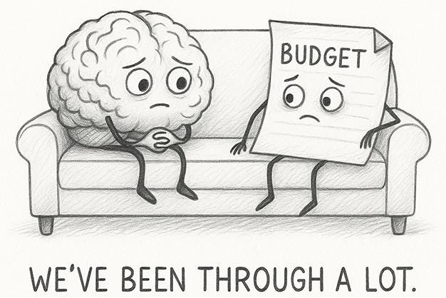 CARTOON OF A BRAIN AND A BUDGET SITTING ON A COUCH DOING THERAPY TOGETHER. CAPTION: "WE'VE BEEN THROUGH A LOT."