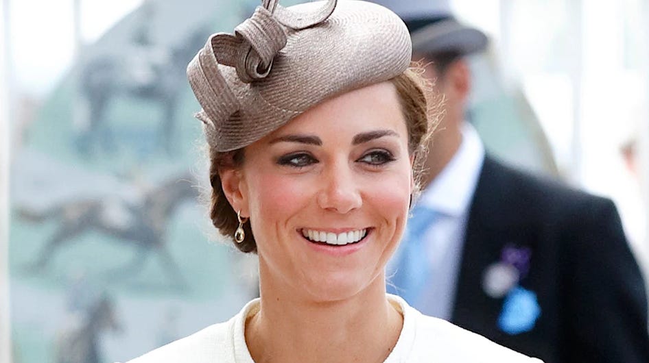Princess Catherine smiling wearing a biege fascinator Princess Catherine smiling wearing a biege fascinator