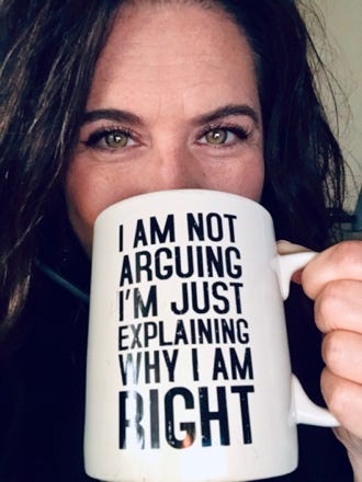 A person holding a white mug with black text

AI-generated content may be incorrect.