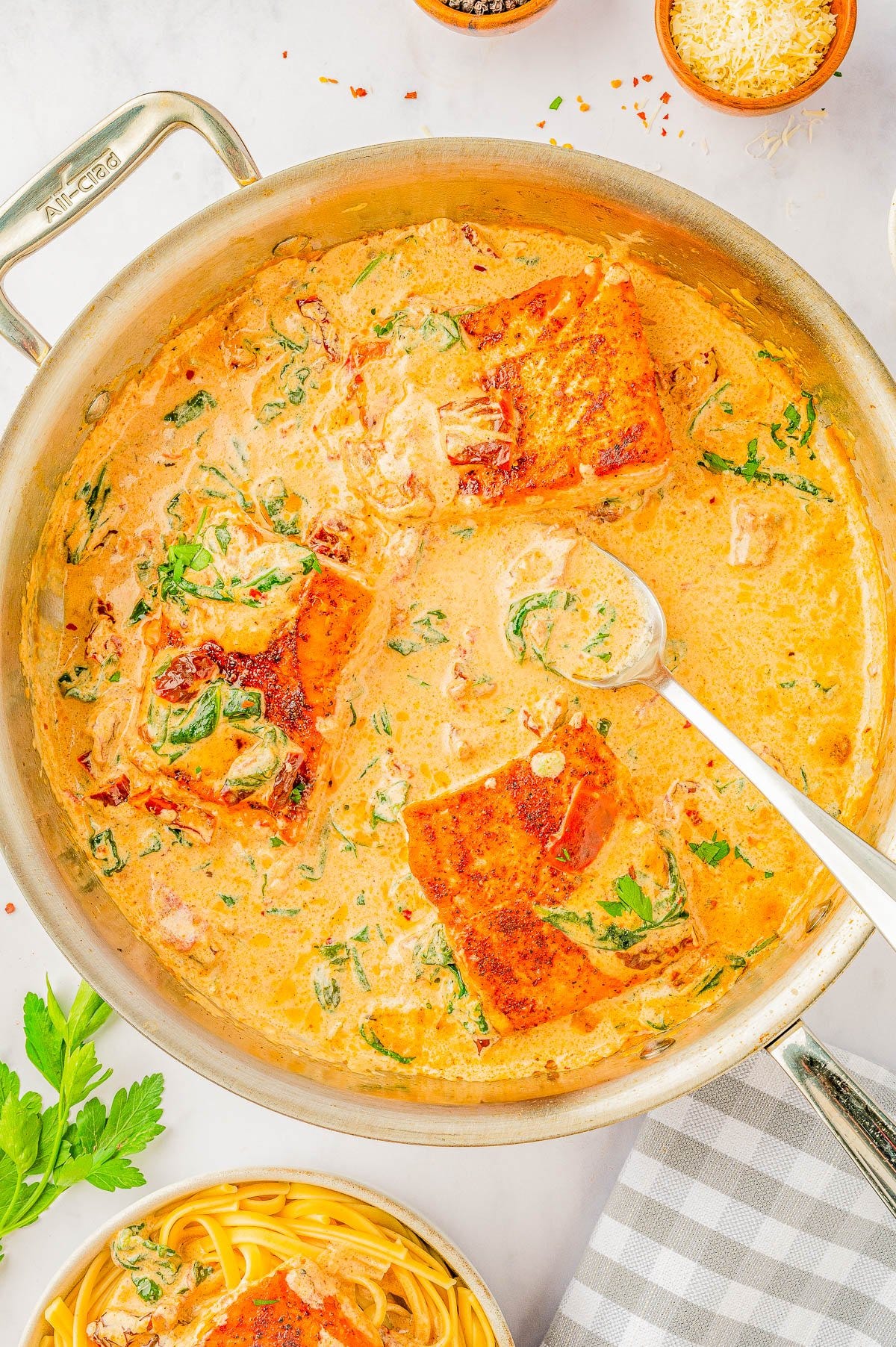 Creamy Garlic Butter Tuscan Salmon in a skillet. 