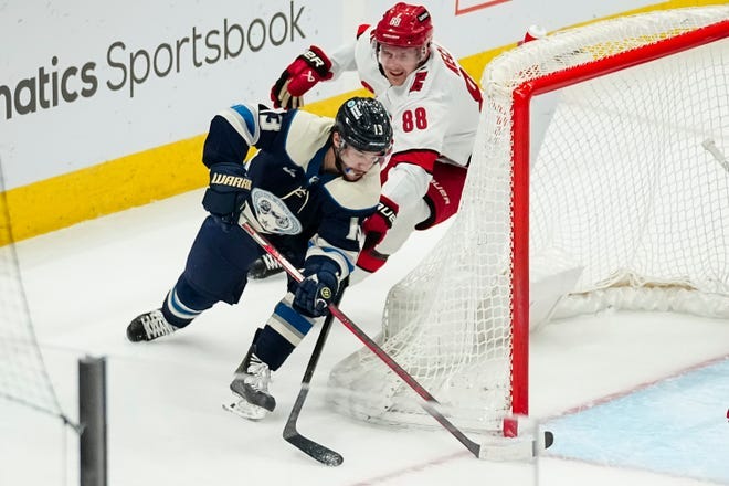 Columbus Blue Jackets left wing Johnny Gaudreau scores a wraparound goal past Carolina Hurricanes center Martin Necas.
