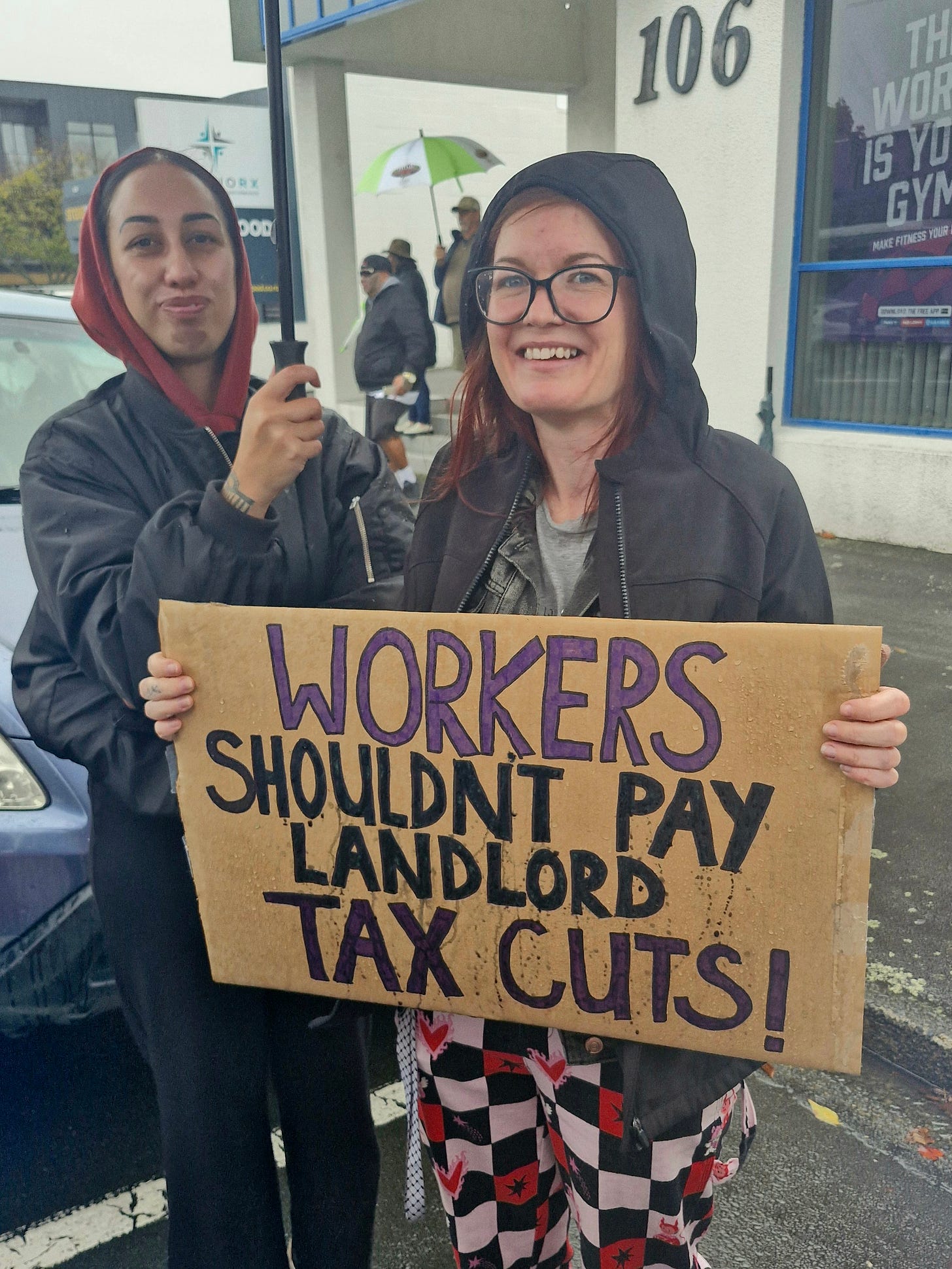 sign reads: workers shouldn't pay  landlords tax cuts