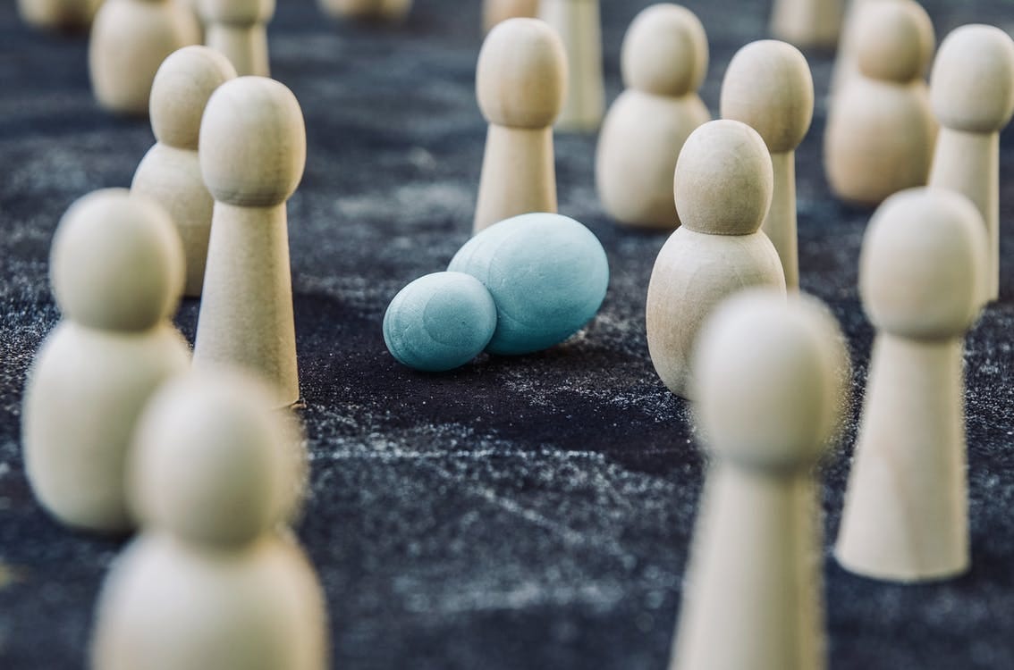 Free Wooden figures placed among fallen representing concept of breakdown during fight against public opinion and social order Stock Photo