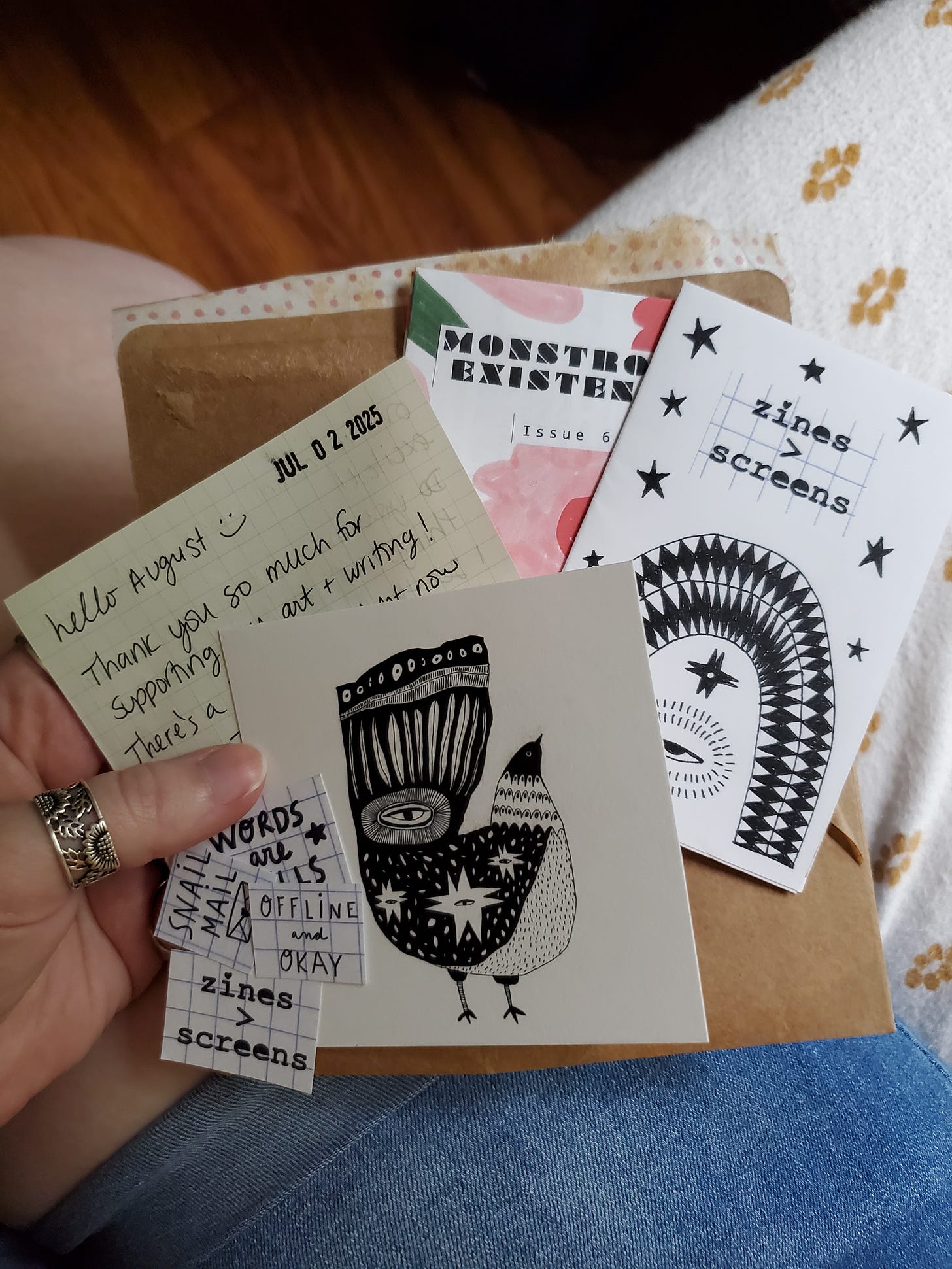 A couple of zines, a small print, a handwritten note, and some other small goodies that came in the envelope in the previous photo.