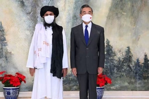 China-Afghan ties: Chinese Foreign Minister Wang Yi with Taliban leader Abdul Ghani Baradar (left) during a visit by a Taliban delegation to China in July 2021. (Reuters Files)