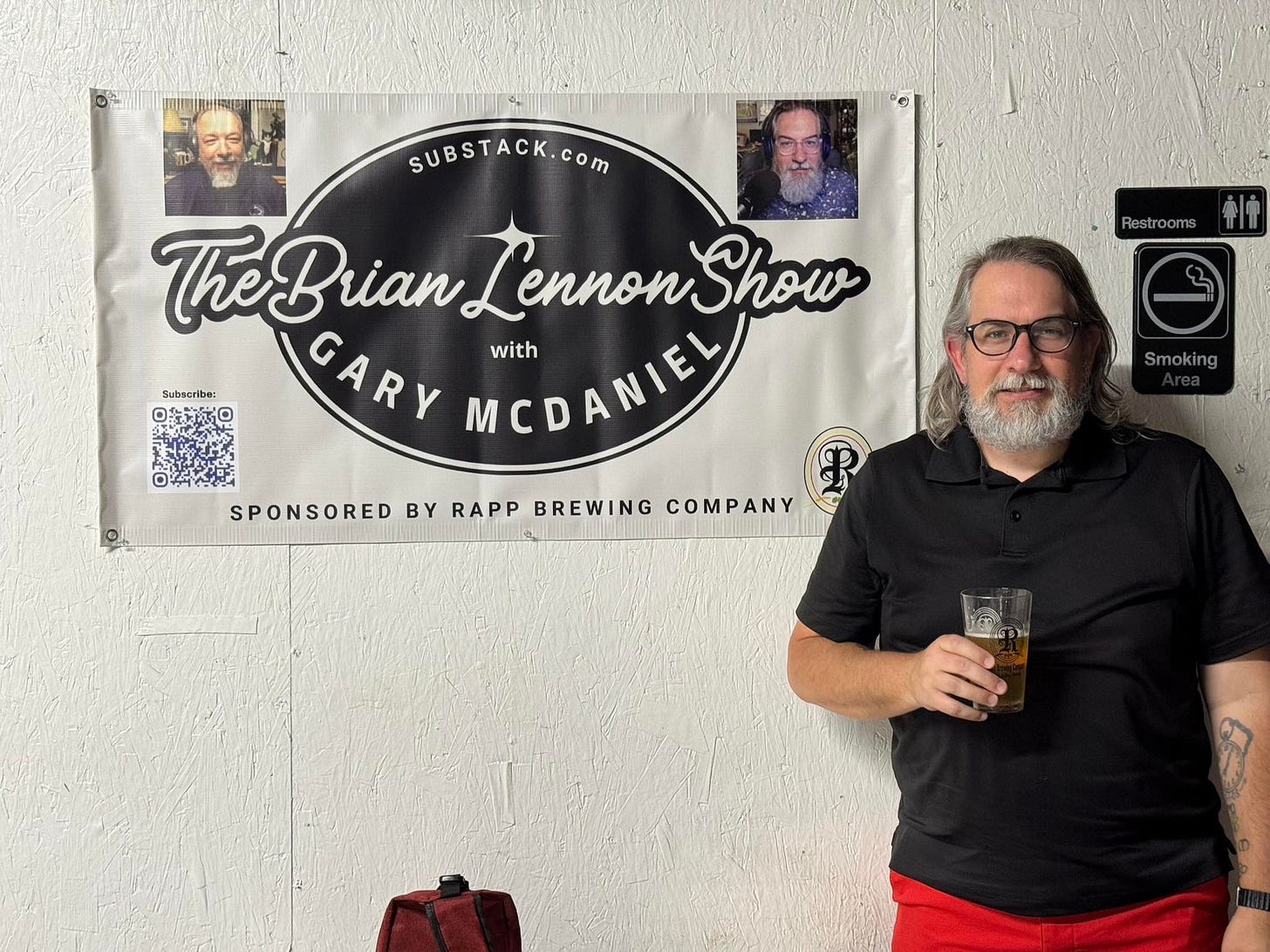 May be an image of 3 people, beard, beer and text that says 'Restrooms ቁ! SUBSTACK.com TheBrian The Show CARY Lennon TreBranLennonShow MCDANELA MEDANIEL with SPONSORED BY RAPP BREWING COMPANY Smoking TE'