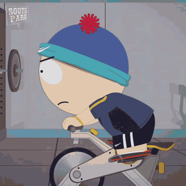 stanley from south park rides an exercise bike in front of a sign that says south park