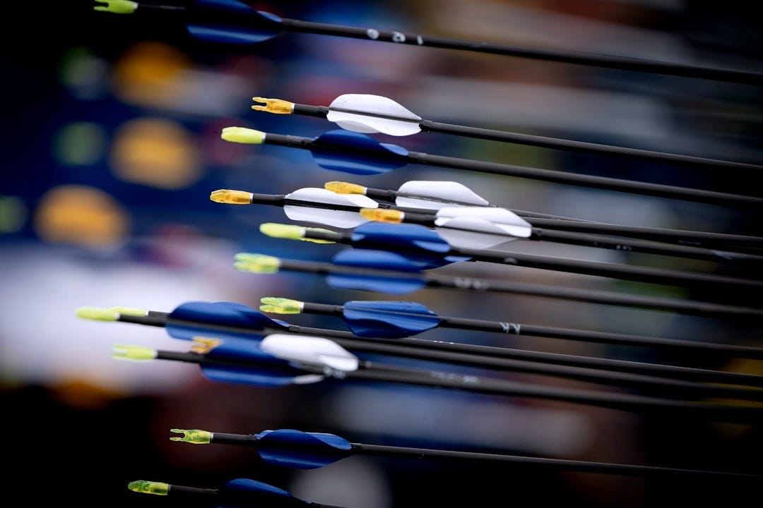 Archery arrows with blue, white fletching and yellow nocks Archery arrows with blue, white fletching and yellow nocks