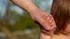Man holds hand of a child Man holds hand of a child