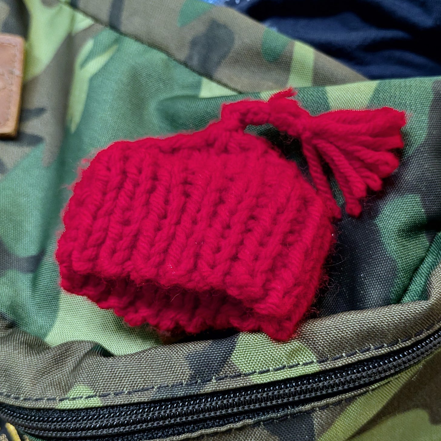 Picture of a small red crocheted hat, similar to those worn in Norway during NAZI occupation and in use today as a protest against ICE. Picture of a small red crocheted hat, similar to those worn in Norway during NAZI occupation and in use today as a protest against ICE.