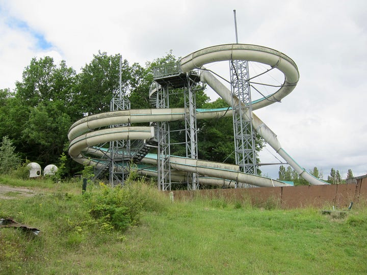 An abandoned slide and grafitti
