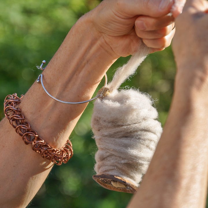 Diptych: Fingers with needle and fingers holding strand of wool.