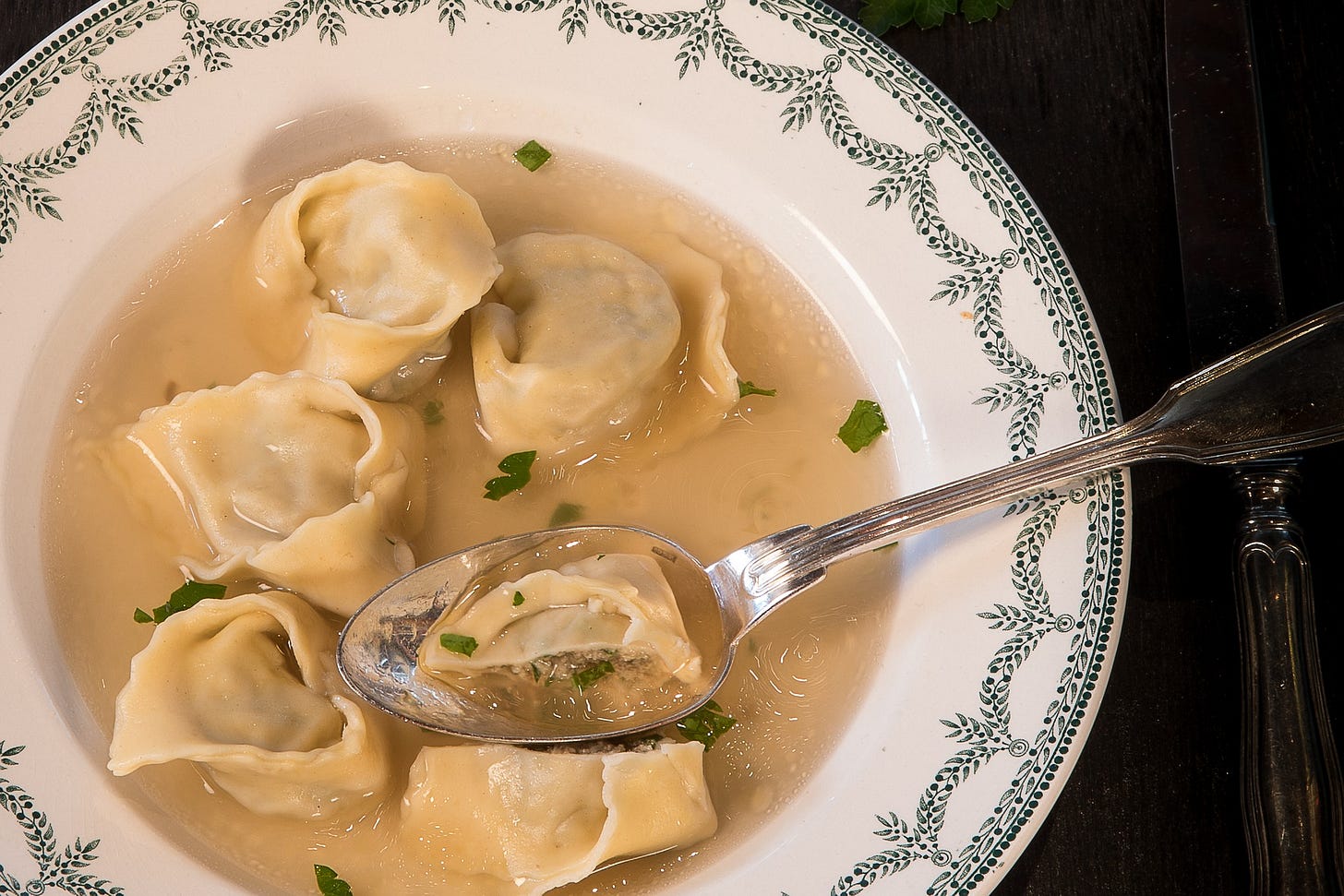 Ravioli in a bowl with a silver spoon. 