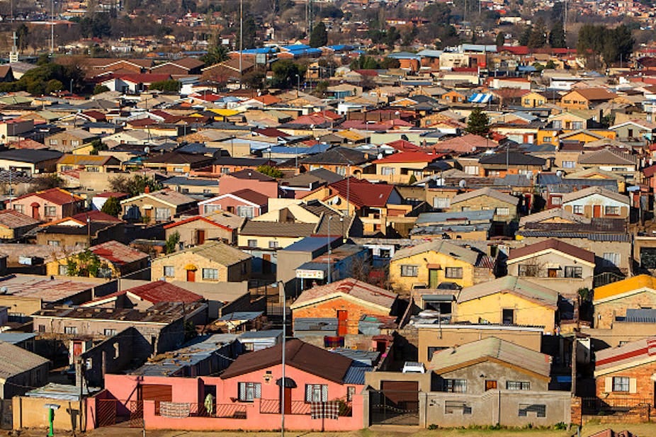 Aerial view of dense settlement of houses of similar design. Aerial view of dense settlement of houses of similar design.