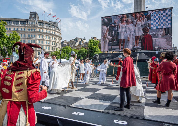 People forming a living chess set, in costume on a giant chess board in Trafalgar Square People forming a living chess set, in costume on a giant chess board in Trafalgar Square