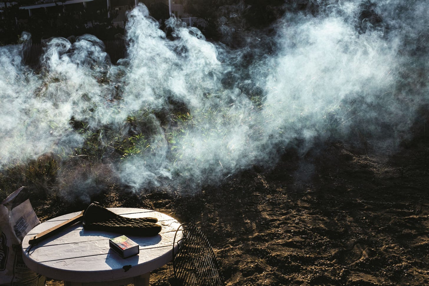 clear barbeque smoke and a table with matches and a mitt