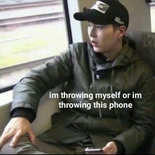 Min Yoongi looking out the window with an annoyed expression. White text "im throwing myself or im throwing this phone" is superimposed on him