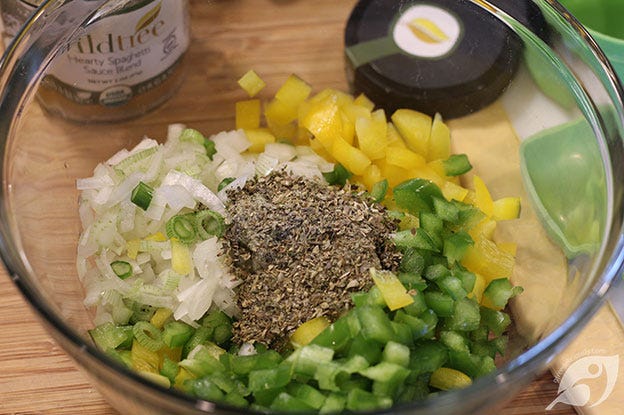 Showing the yellow and green bell pepper and oniion in the bowl with the seasoning blend. Showing the yellow and green bell pepper and oniion in the bowl with the seasoning blend.