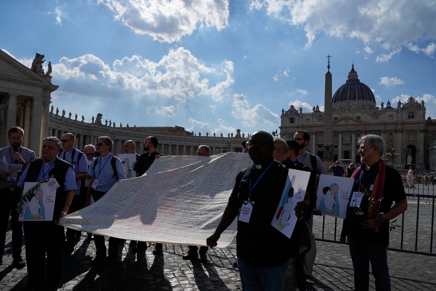 Priests carry a shroud of children’s names near St. Peter’s Square Priests carry a shroud of children’s names near St. Peter’s Square