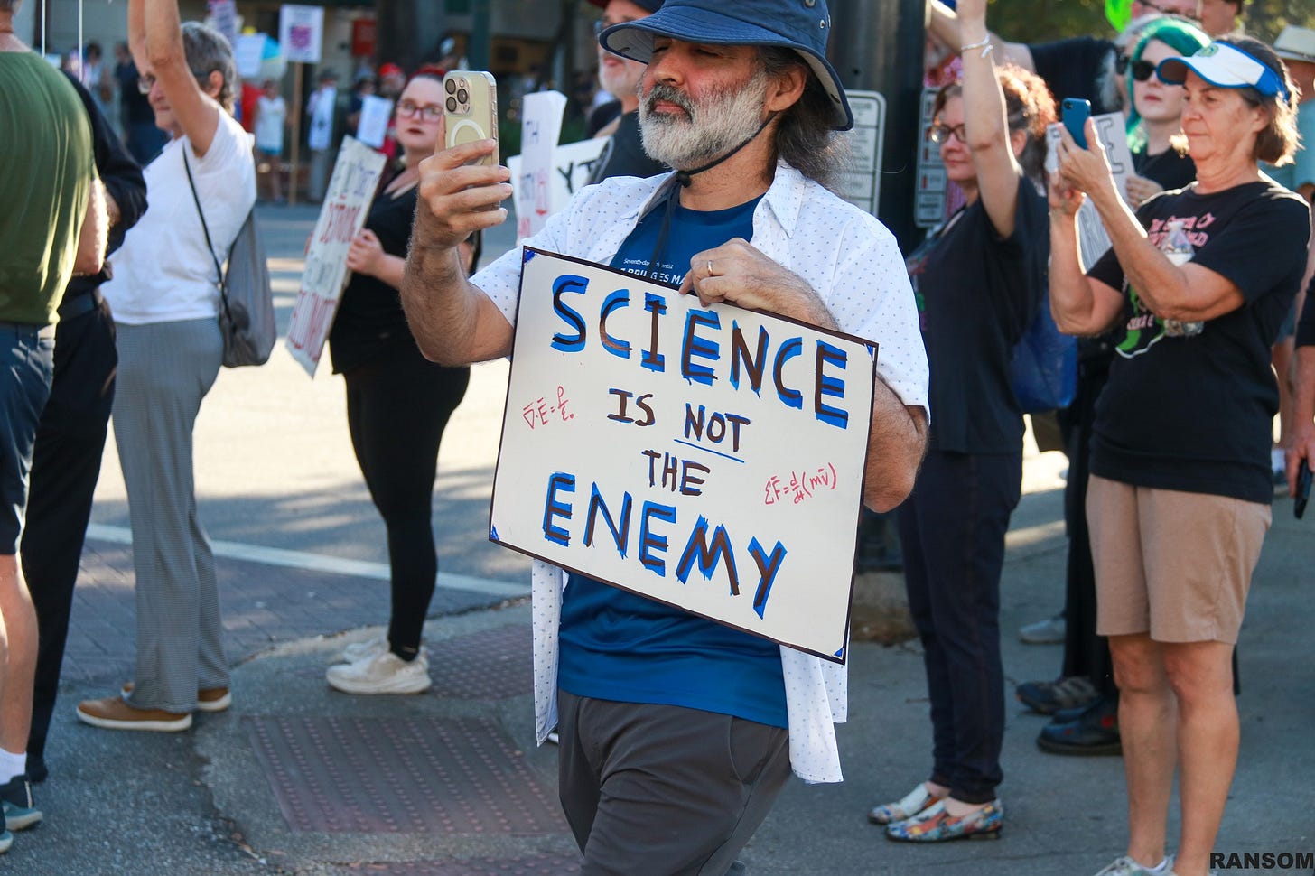 May be an image of one or more people, crowd and text