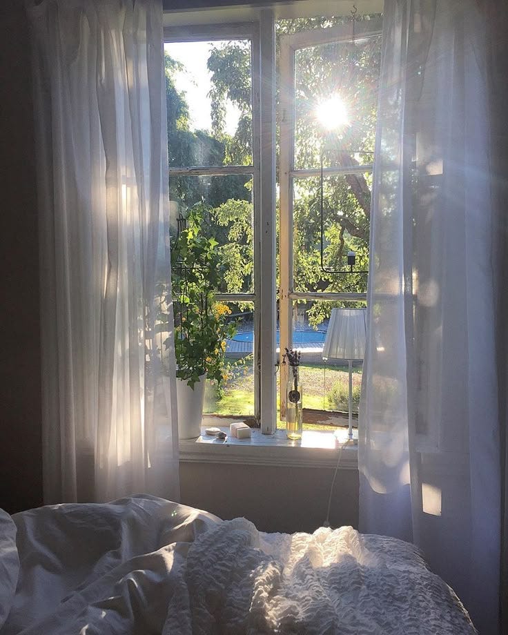 This may contain: the sun is shining through the window in the bedroom This may contain: the sun is shining through the window in the bedroom
