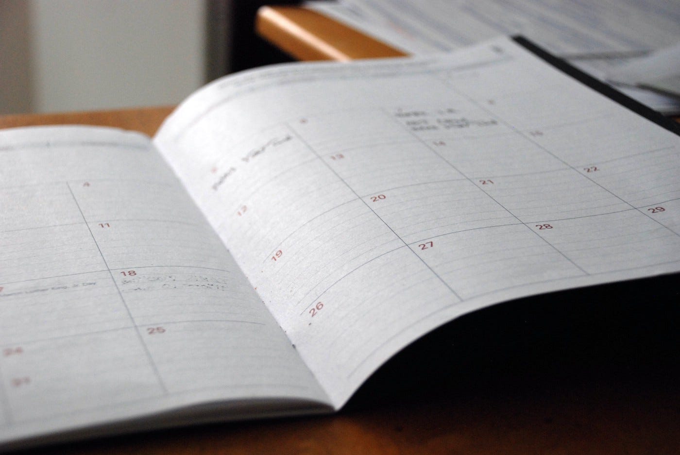 A photograph of a monthly planner. A photograph of a monthly planner.