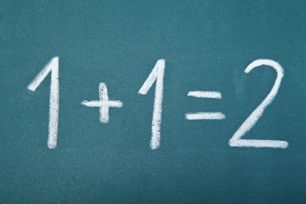 Premium Photo | Basic arithmetic equation written on a chalkboard - 1 + 1 = 2