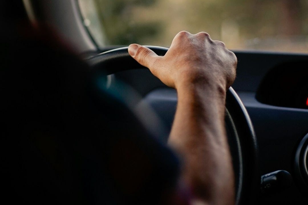 person driving car during daytime