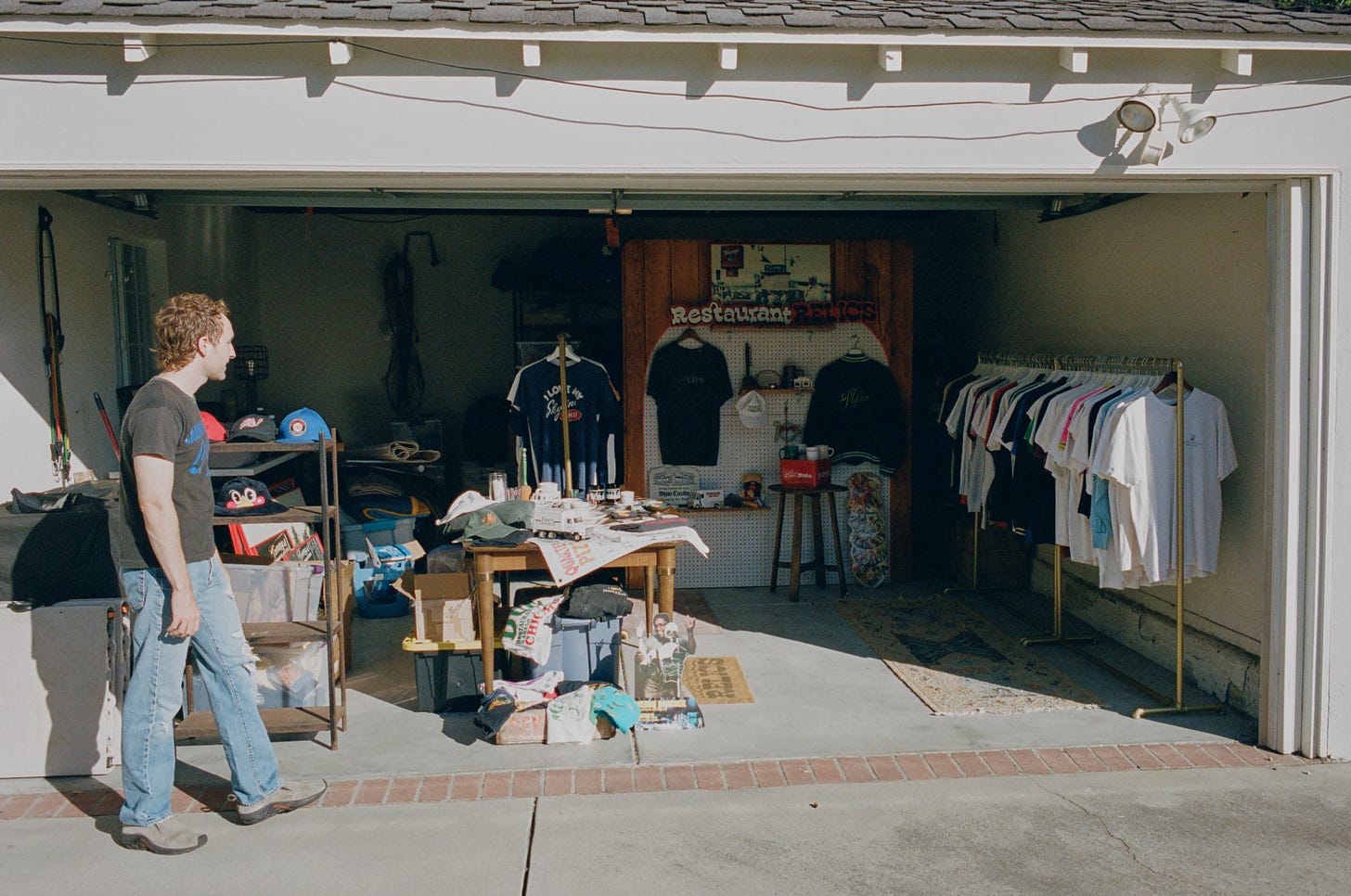 Justin gazes at his garage full of curiosities