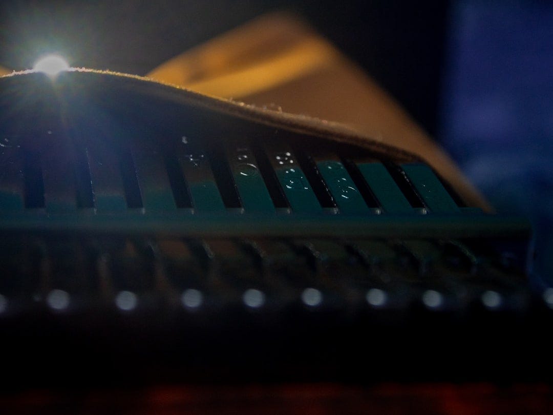 a close up of a metal object with a light shining on itClose-up of a thumb piano (kalimba/mbira) under stage lighting a close up of a metal object with a light shining on itClose-up of a thumb piano (kalimba/mbira) under stage lighting