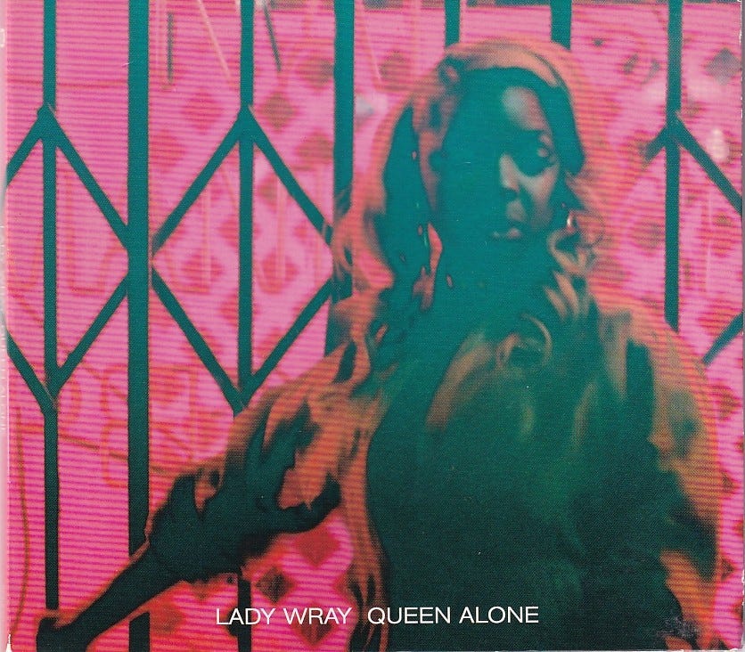 the cover for Queen Alone by Lady Wray. a Black woman poses in front of a black gate. the image has blurring effects and she poses solemnly in pink glowing light. the cover for Queen Alone by Lady Wray. a Black woman poses in front of a black gate. the image has blurring effects and she poses solemnly in pink glowing light.