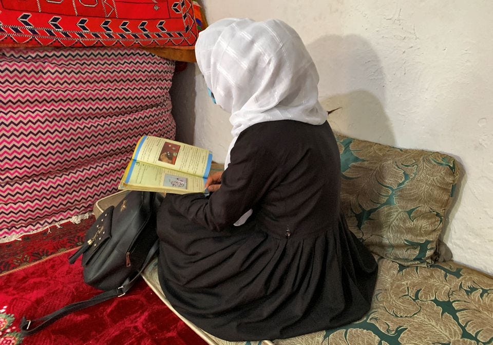 A person sitting on a couch reading a book

Description automatically generated with low confidence